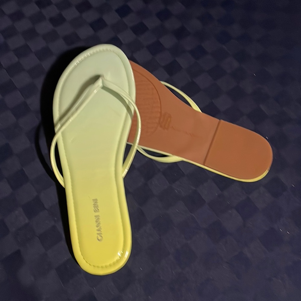 Light green n yellowish flip flops.